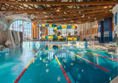 a large swimming pool with a water slide at Premium Vintage Apartament by Krakow Home in Kraków