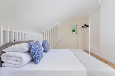 a bedroom with a white bed with blue pillows at Apartment with balcony - Rejtana 10 in Kraków