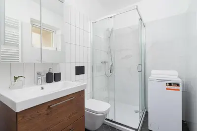 a bathroom with a toilet and a sink and a shower at Apartment with balcony - Rejtana 10 in Kraków