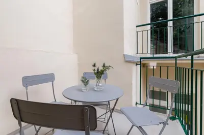 a table and two chairs on a balcony at Apartment with balcony - Rejtana 10 in Kraków