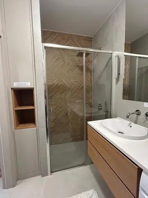 a bathroom with a shower and a sink at Tutu Kraków Comfort in Kraków