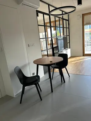 a table and two chairs in a room at Tutu Kraków Comfort in Kraków