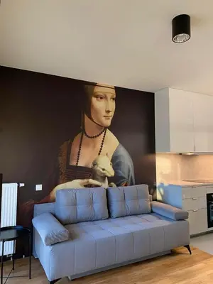 a wall with a painting of a woman with aumed at Tutu Kraków Comfort in Kraków