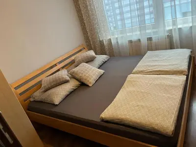 a bed with two pillows on it in a room at Noclegi u Eweliny in Zator