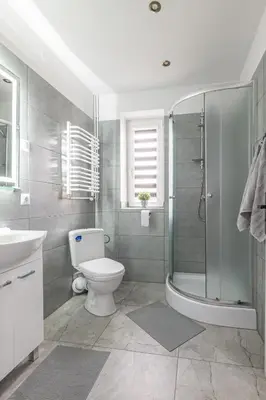 a bathroom with a shower and a toilet and a sink at Noclegi u Eweliny in Zator