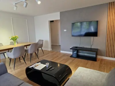 a living room with a table and a flat screen tv at Moje miejsce Zator in Zator