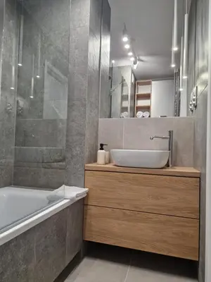 a bathroom with a tub and a sink and a bath tub at Moje miejsce Zator in Zator