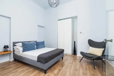 a bedroom with a bed and a table and a chair at One bedroom apartment - Sarego 28 Street in Kraków
