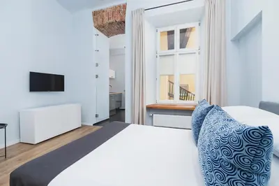 a bedroom with a white bed and a window at One bedroom apartment - Sarego 28 Street in Kraków