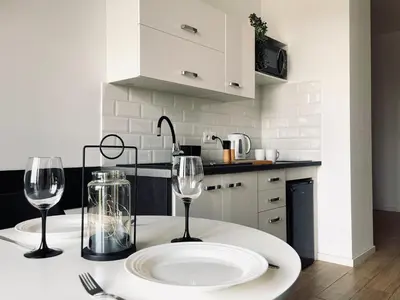 a kitchen with two wine glasses on a table at Zator 36 by Housine in Zator