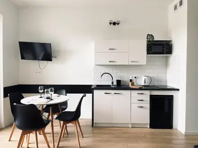 a kitchen with a table with a wine glass at Zator 36 by Housine in Zator