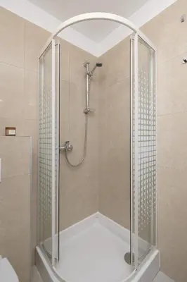 a shower with a glass enclosure in a bathroom at Studio apartment with AC - Długa 65 in Kraków