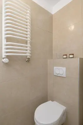 a bathroom with a toilet and a window at Studio apartment with AC - Długa 65 in Kraków
