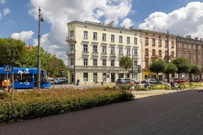 a building on a street with a bus in front of it at Studio apartment with AC - Długa 65 in Kraków