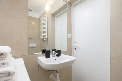 a bathroom with a sink and a mirror at Studio apartment with AC - Długa 65 in Kraków