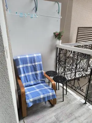 a blue and white chair sitting on a balcony at wawel hostel in Kraków