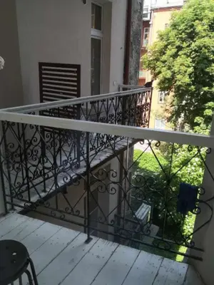 a balcony with a wrought iron railing on a house at wawel hostel in Kraków
