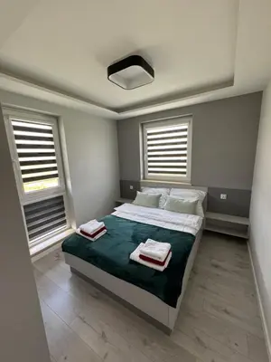a bedroom with a bed with two towels on it at Apartament Jasmin in Zator
