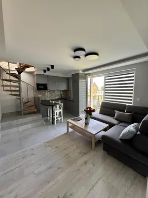 a living room with a couch and a table at Apartament Jasmin in Zator