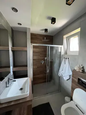a bathroom with a sink and a shower and a toilet at Apartament Jasmin in Zator