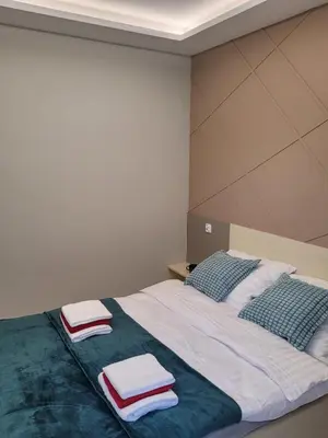 a bedroom with a bed with towels on it at Apartament Jasmin in Zator