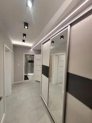 a hallway with mirrors and a walk in closet at Apartament Jasmin in Zator