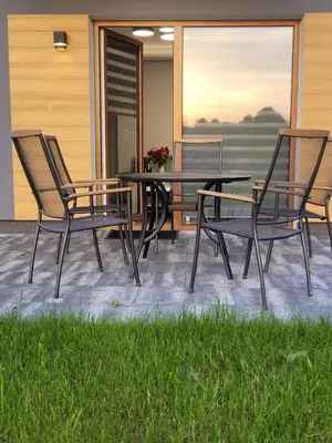a patio with three chairs and a table and a table at Apartament Jasmin in Zator