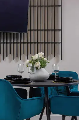 a table with two blue chairs and a vase of flowers at Exclusive Apartment on the Vistula River in Kraków by Renters Prestige in Kraków
