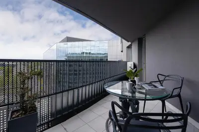 a balcony with a glass table and chairs on it at Exclusive Apartment on the Vistula River in Kraków by Renters Prestige in Kraków