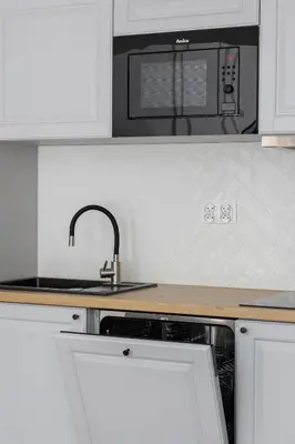 a kitchen with a sink and a microwave at Kazimierz - Balcony Apartment- Starowiślna 41 in Kraków