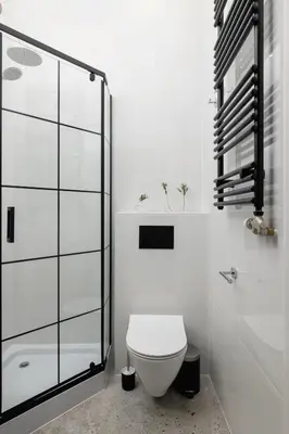 a bathroom with a toilet and a glass shower at Kazimierz - Balcony Apartment- Starowiślna 41 in Kraków
