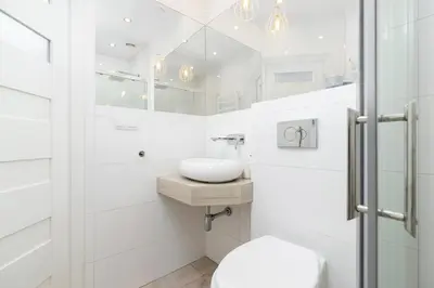 a bedroom with a bed with a brick wall at Two bedroom apartment - Starowiślna 36 in Kraków