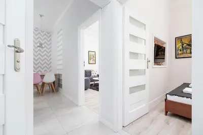 a white room with a door leading to a bedroom at Two bedroom apartment - Starowiślna 36 in Kraków