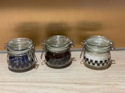 three jars of food sitting on top of a table at APARTAMENT KRÓLEWSKI CENTRUM NIEPOŁOMICE in Niepołomice