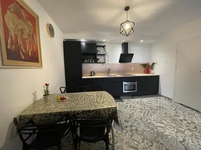 a kitchen with a table with chairs and a sink at APARTAMENT KRÓLEWSKI CENTRUM NIEPOŁOMICE in Niepołomice