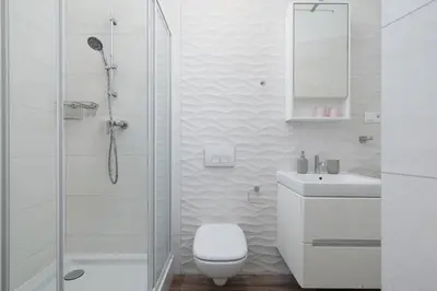 a bathroom with a shower and a toilet and a sink at 1-Bedroom Apartment - Brodzińskiego 3 - Podgórze in Kraków