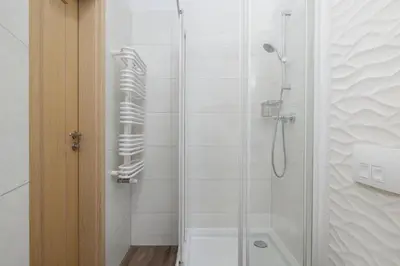 a bathroom with a shower with a glass door at 1-Bedroom Apartment - Brodzińskiego 3 - Podgórze in Kraków