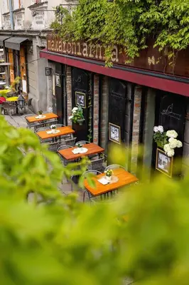 a row of tables and chairs outside of a restaurant at 1-Bedroom Apartment - Brodzińskiego 3 - Podgórze in Kraków