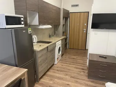 a kitchen with a refrigerator and a washing machine at Apartamenty 3 Kraków Podgórze in Kraków