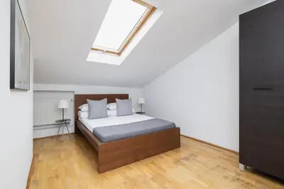 a bedroom with a bed with a skylight at 1 Bedroom Apartment with AC - Dluga 65 Street in Kraków