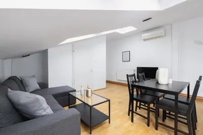 a living room with a couch and a table at 1 Bedroom Apartment with AC - Dluga 65 Street in Kraków