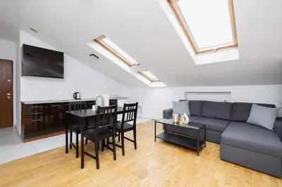 a living room with a couch and a table at 1 Bedroom Apartment with AC - Dluga 65 Street in Kraków