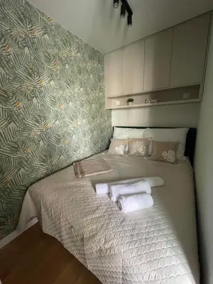 a small bedroom with a bed with towels on it at Apartment 41 in Kraków