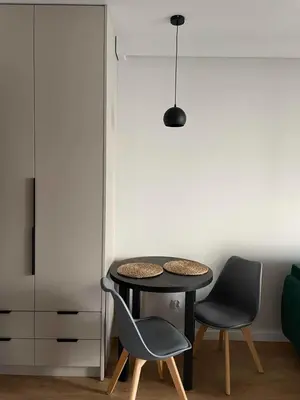 a dining room with a table and two chairs at Apartment 41 in Kraków