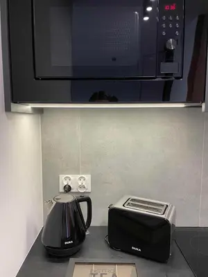 a kitchen counter with a toaster and a microwave at Apartment 41 in Kraków