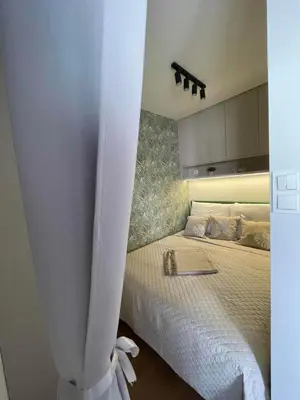 a bedroom with a bed with a white curtain at Apartment 41 in Kraków