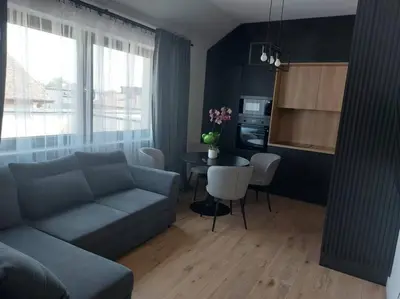 a living room with a couch and a table at Apartament z dużym tarasem, bezpłatny parking, AWG APARTMENTS in Kraków