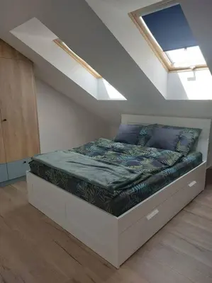 a bedroom with a bed in a attic at Apartament z dużym tarasem, bezpłatny parking, AWG APARTMENTS in Kraków