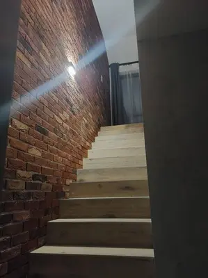 a brick wall and stairs in a room at Apartament z dużym tarasem, bezpłatny parking, AWG APARTMENTS in Kraków