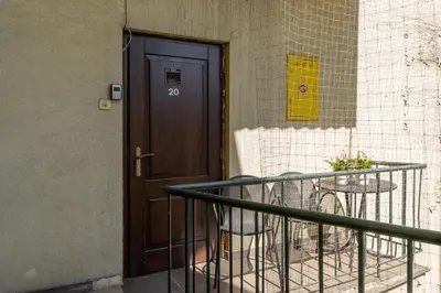 a door to a building with a table next to it at 1-Bedroom Apartment - Długa 65 in Kraków
